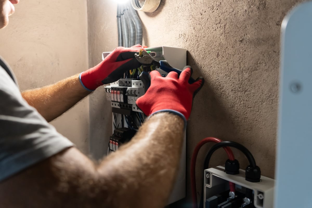 Professional electrician working on electrical panel